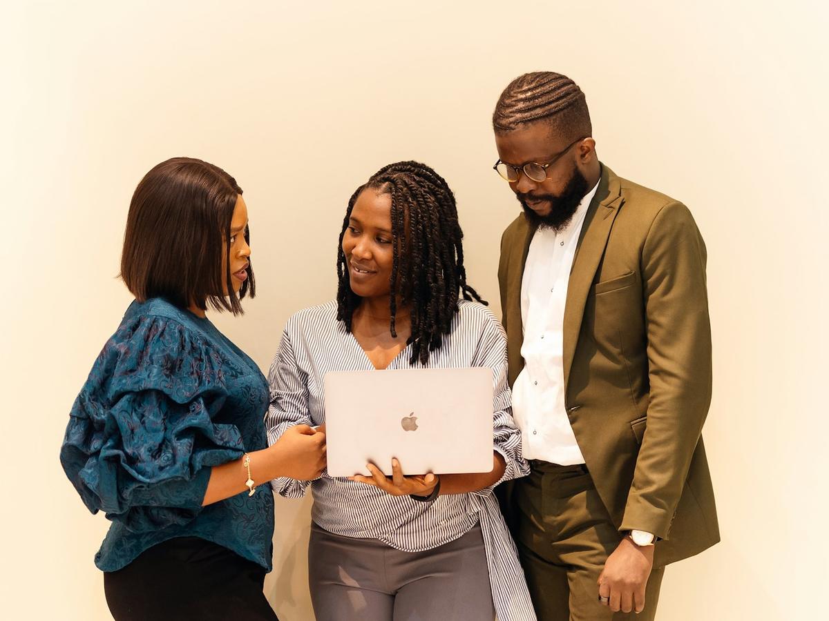 Business team reviewing work together on a laptop